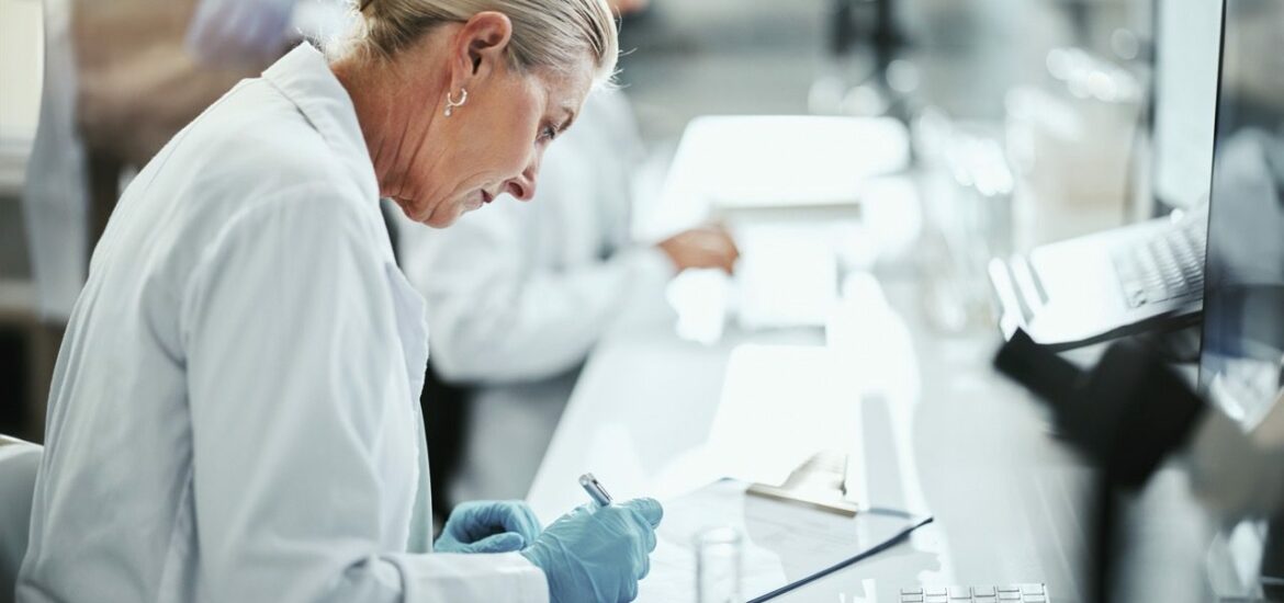 Clipboard, woman and scientist writing in laboratory for medical research on cancer drug trial. Checklist, investigation and female biologist with clinic protocol development for pharmaceutical study.