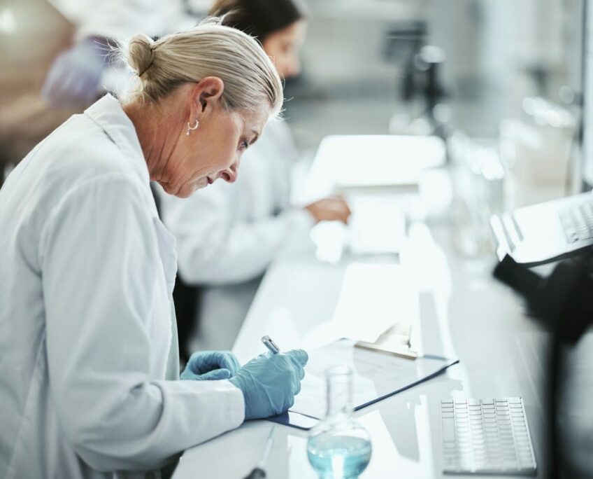Clipboard, woman and scientist writing in laboratory for medical research on cancer drug trial. Checklist, investigation and female biologist with clinic protocol development for pharmaceutical study Clipboard, woman and scientist writing in laboratory for medical research on cancer drug trial. Checklist, investigation and female biologist with clinic protocol development for pharmaceutical study.